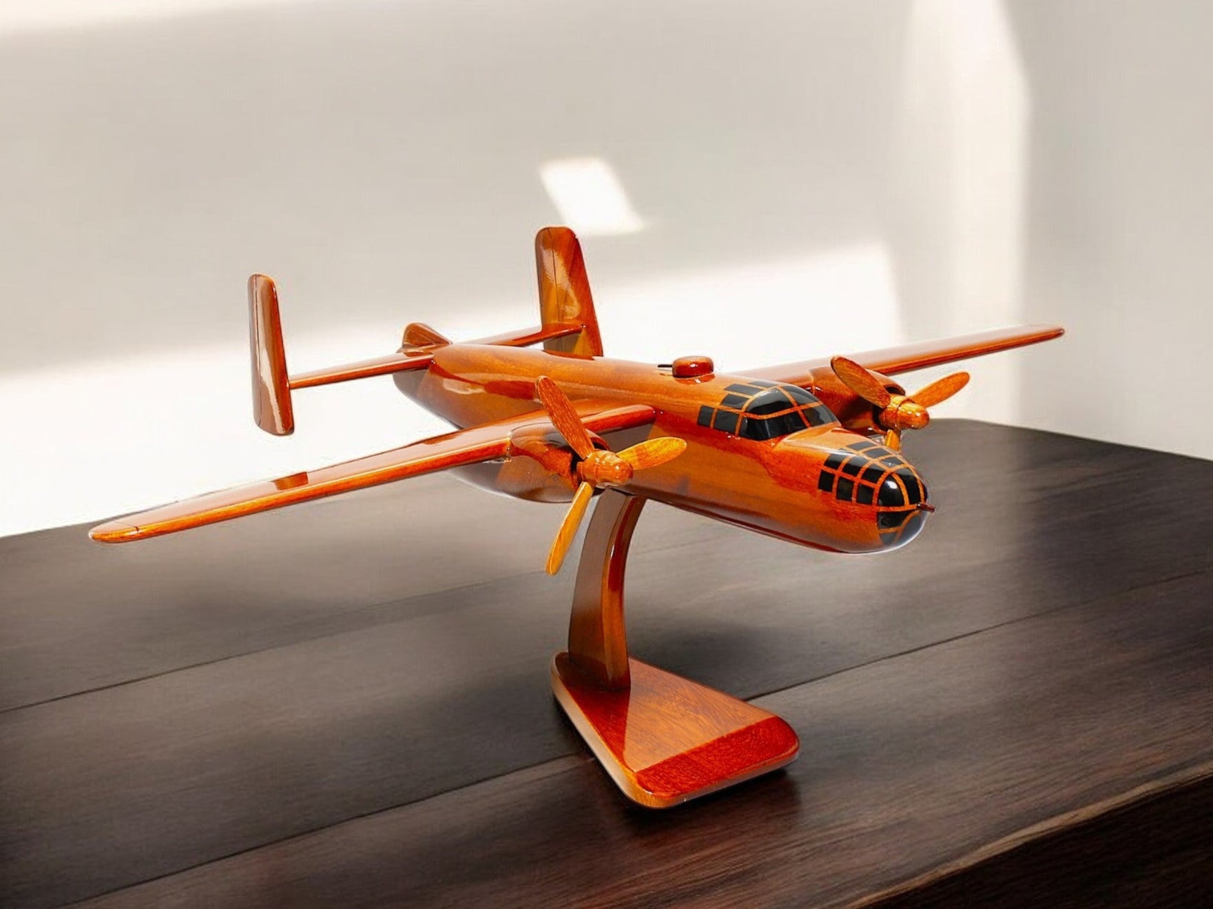 Handcrafted B-25 Mitchell wooden model airplane on mahogany stand