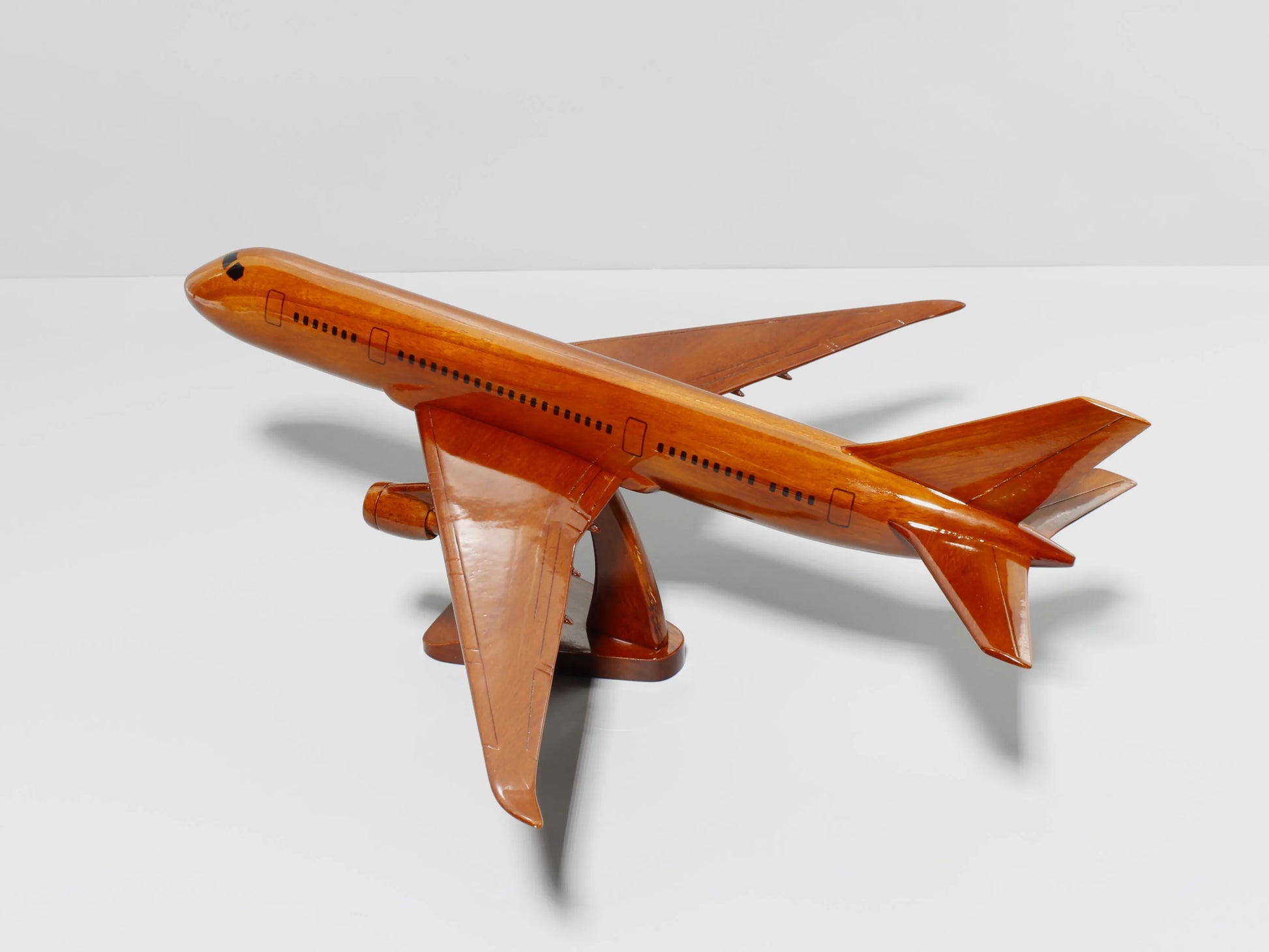 Back-diagonal view of Boeing 787 wooden model jet – made from solid mahogany