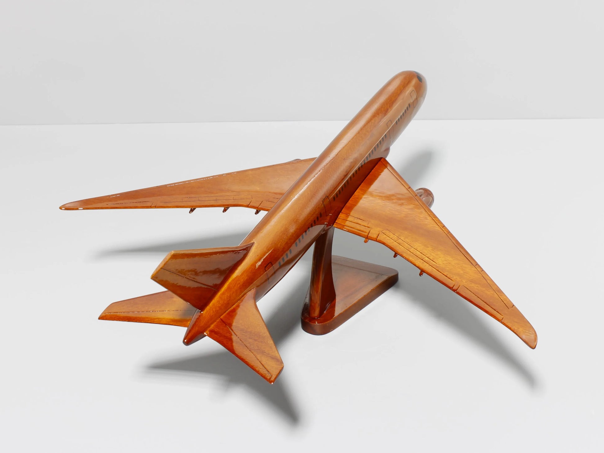 Top-down view of handcrafted Boeing 787 model aircraft – wooden collectible