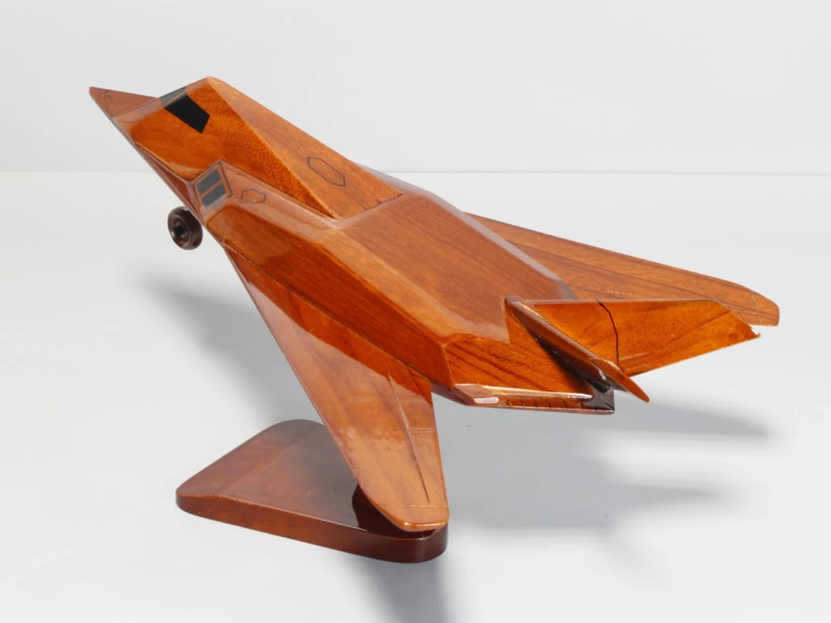 Back angle display of handcrafted F-117 Nighthawk wood model