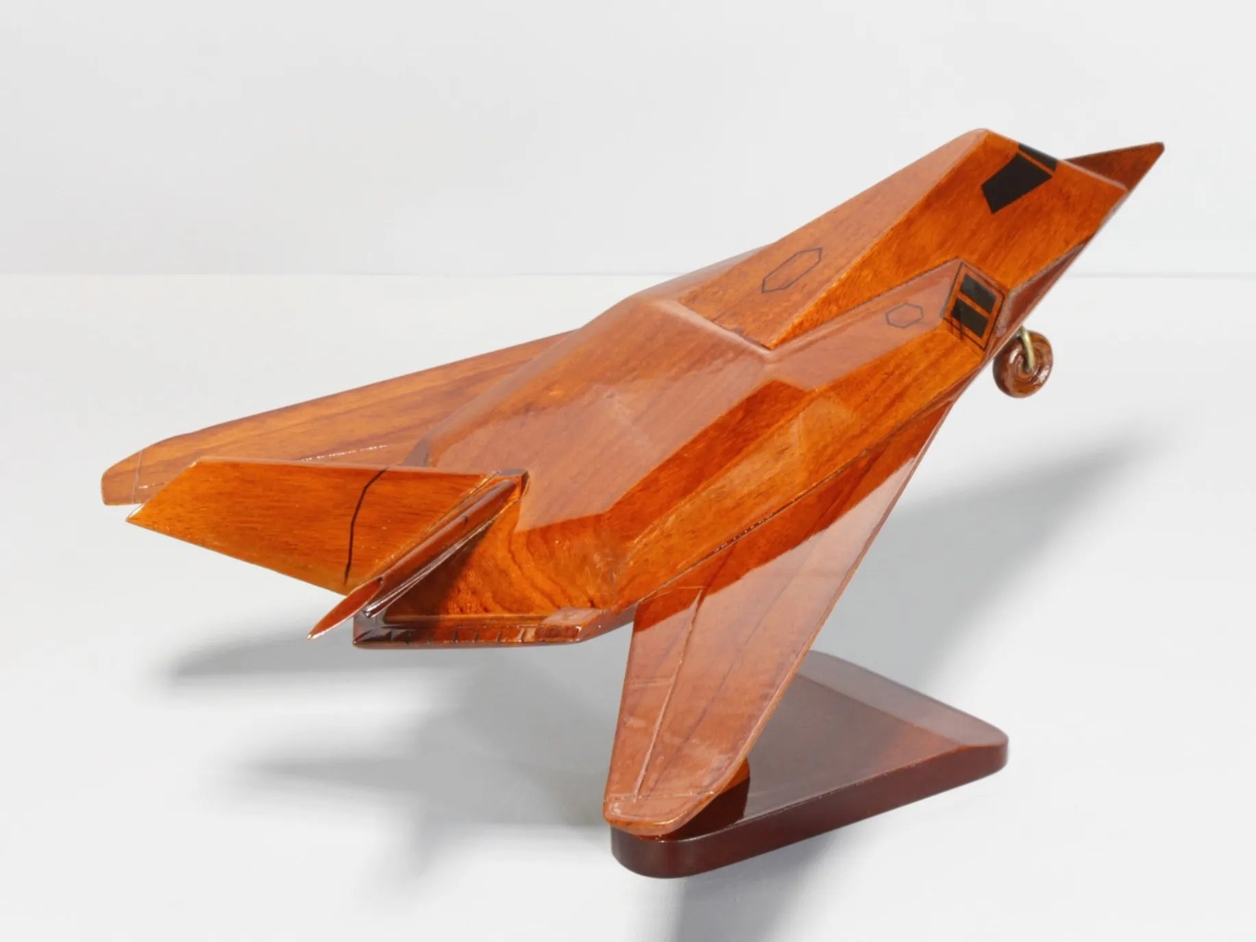 Back-left view of F-117 stealth aircraft model made from polished mahogany