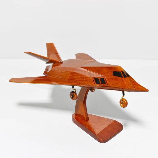 Left side view of F-117 stealth fighter jet model in rich mahogany