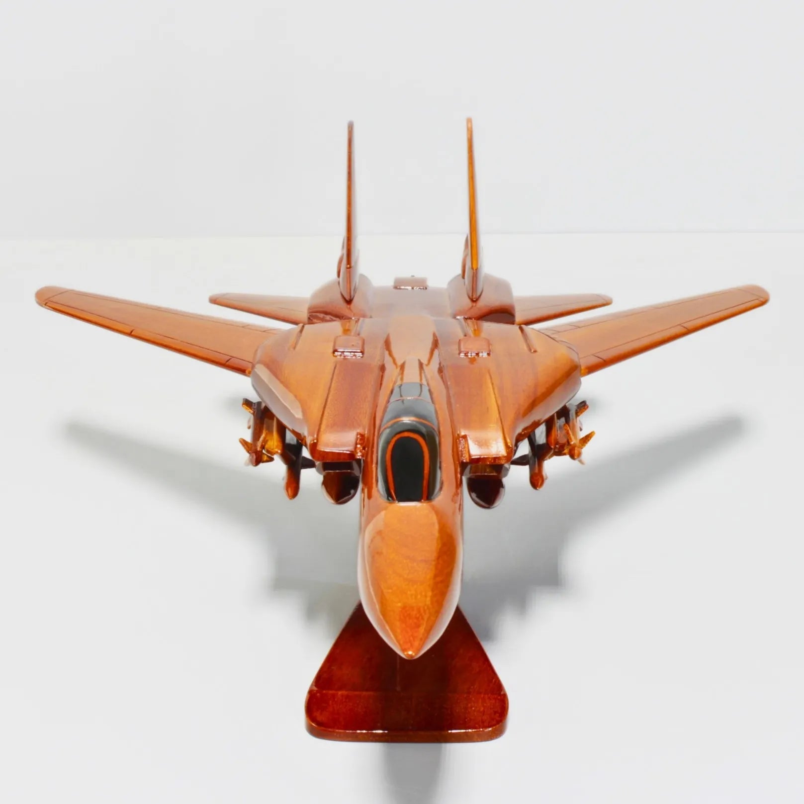 Head-on front view of F-14 Tomcat fighter jet wood model on display stand