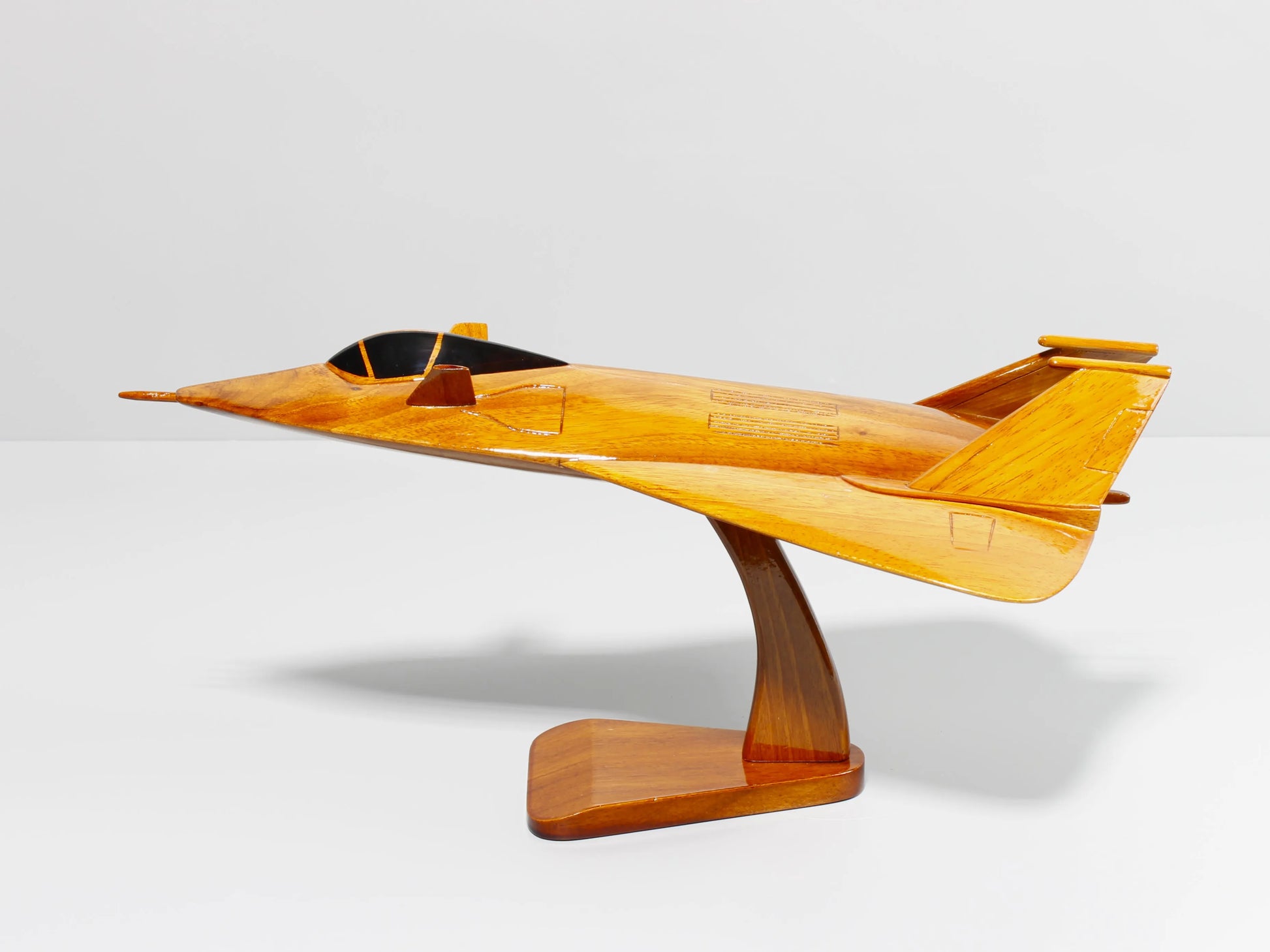 Clean profile shot of handcrafted F-19 stealth aircraft wood model