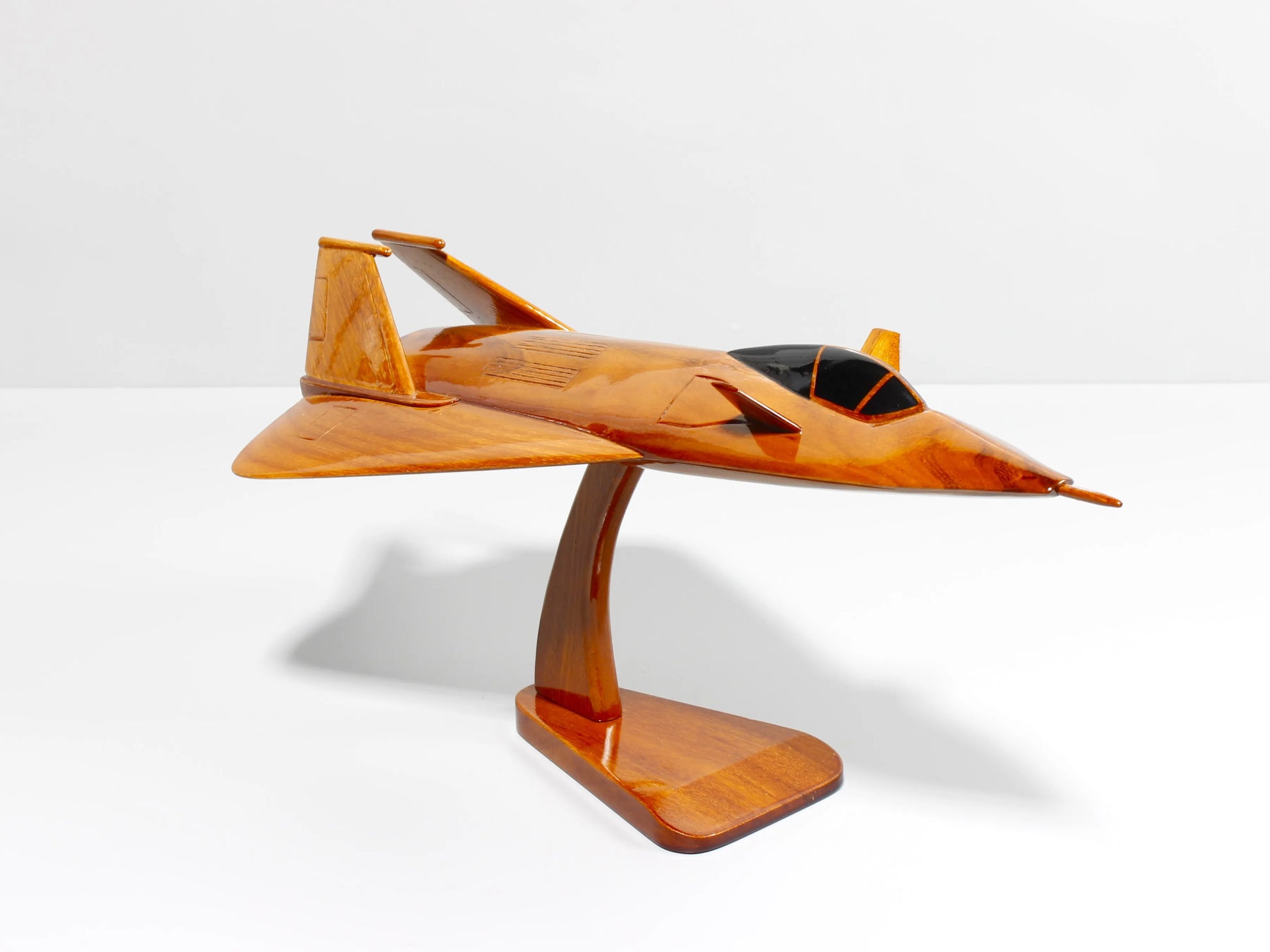 Top angle view of F-19 stealth fighter mahogany jet model on base