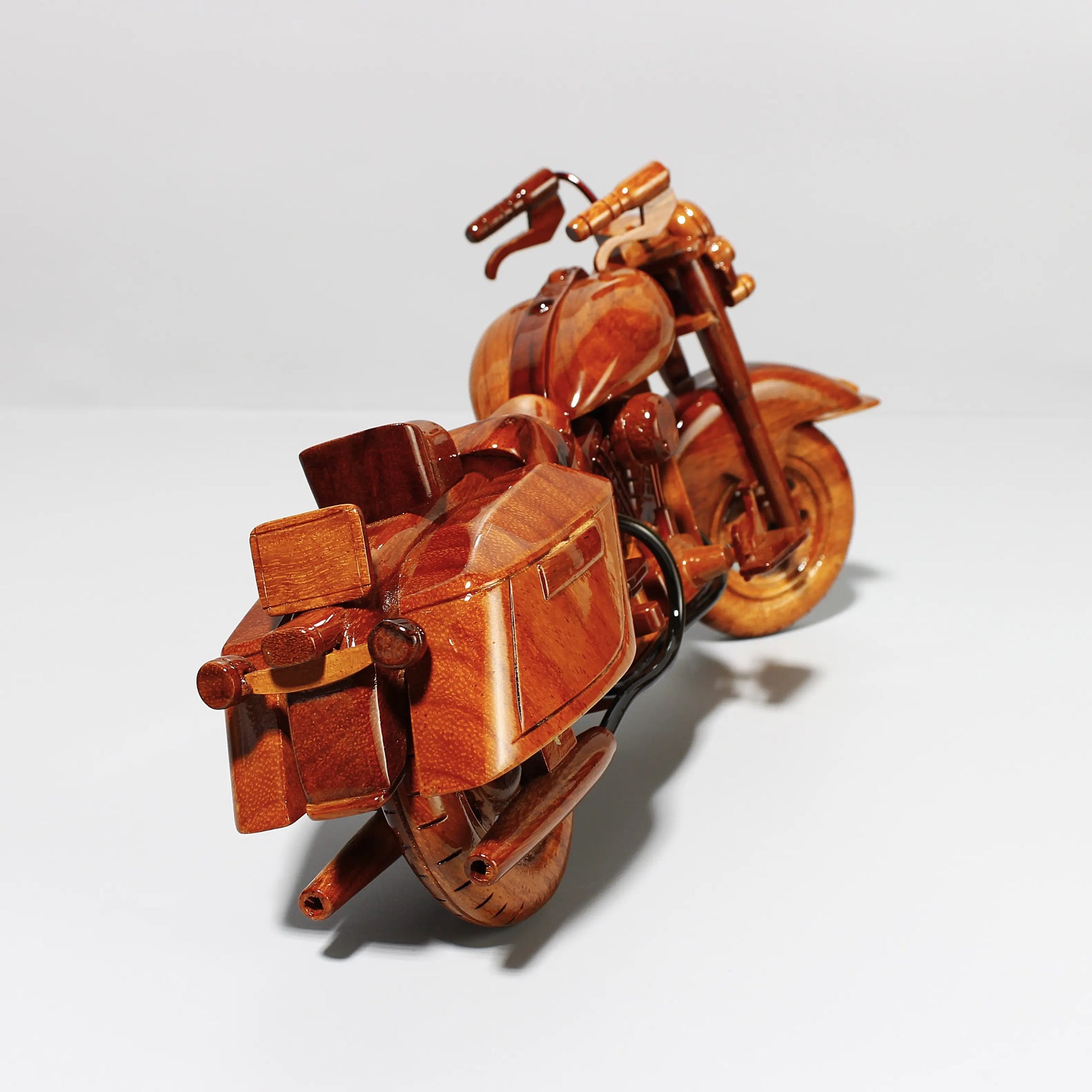 Rear angle of Harley Road King wooden model showing saddlebags and exhaust