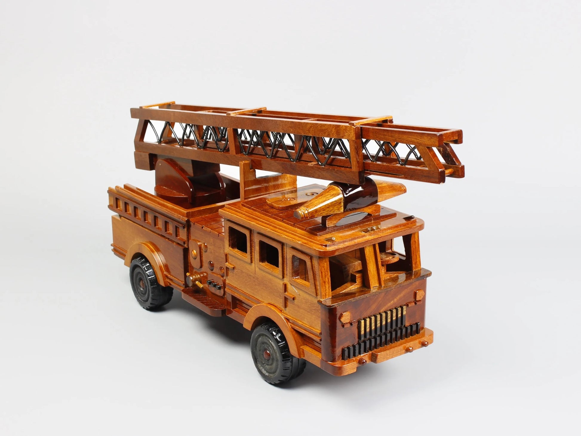 Diagonal front view of wooden fire engine model – handcrafted mahogany