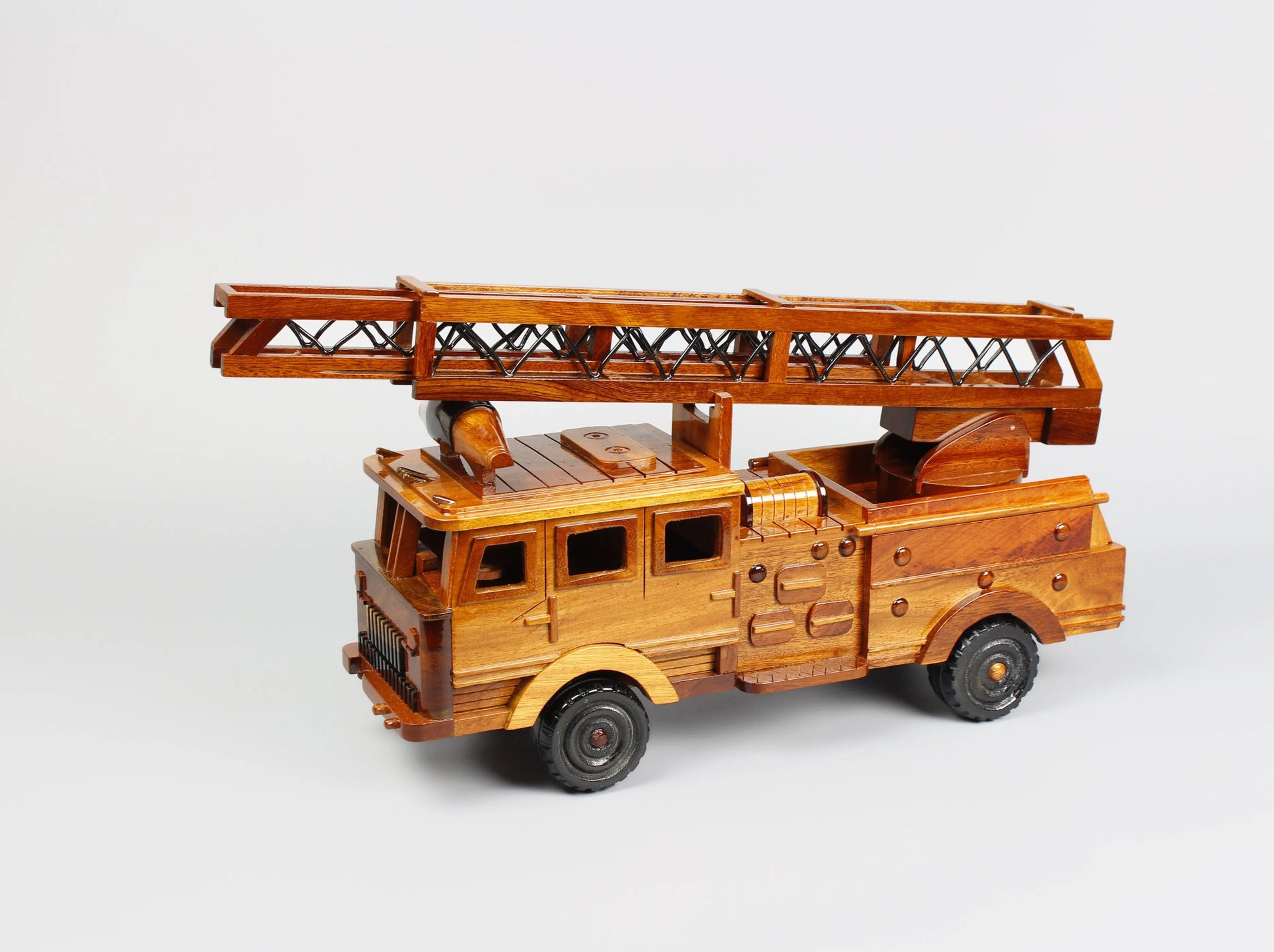 Low-angle side shot of handcrafted ladder fire truck model