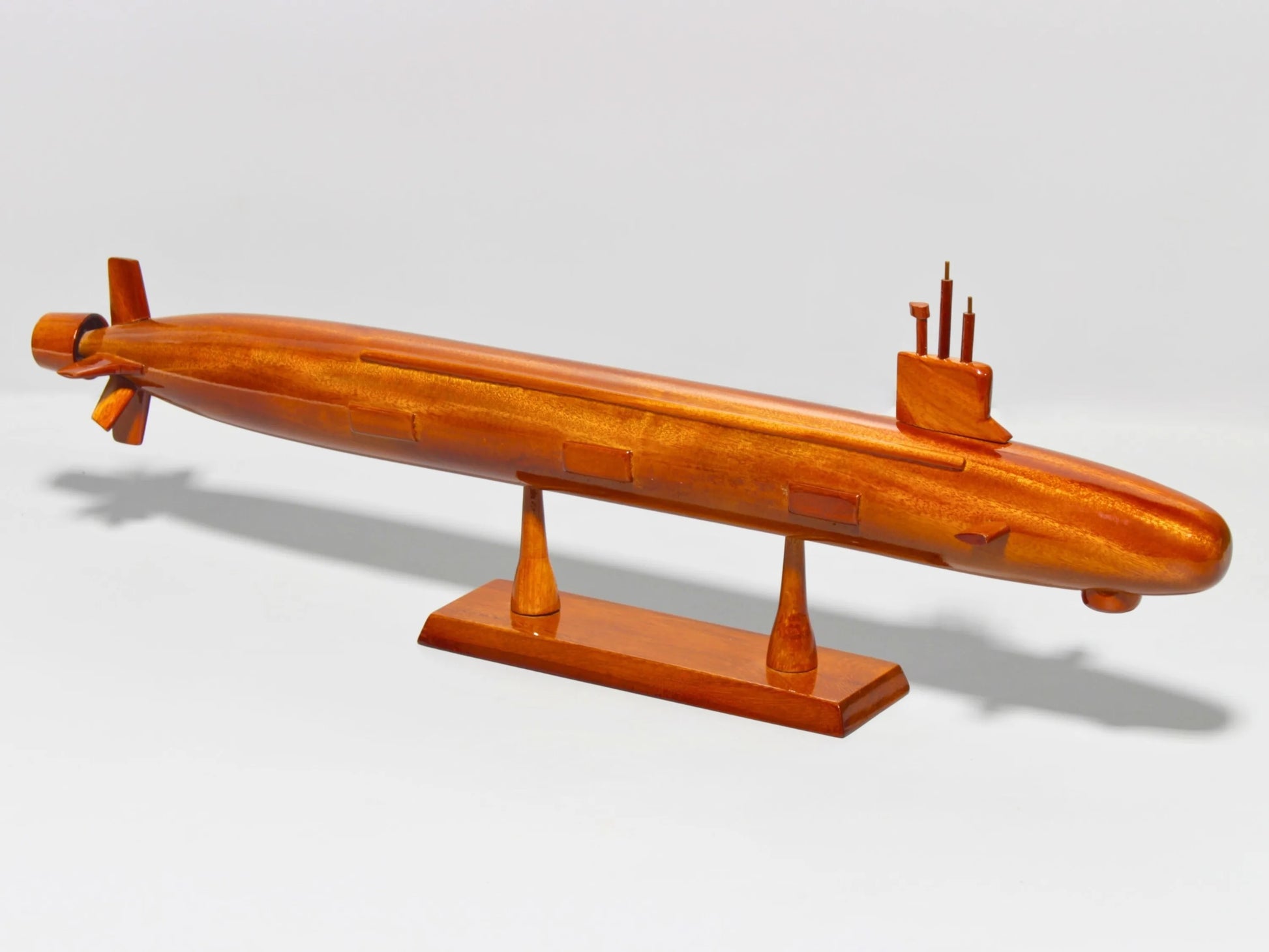 Top angled shot of Virginia-class submarine model in mahogany wood