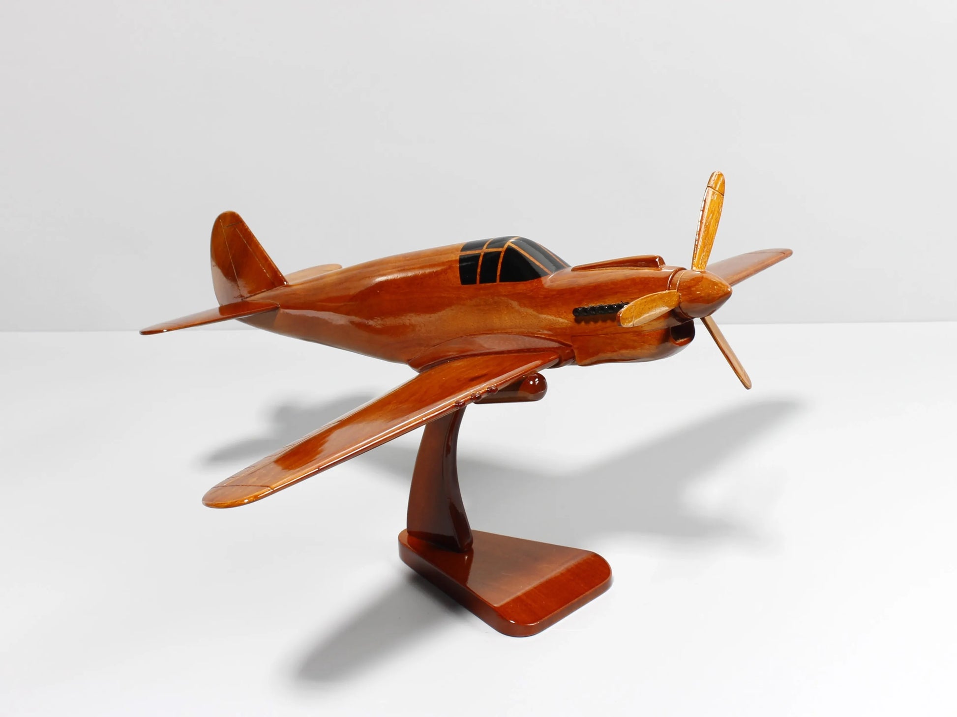 Side angle of P-40 Warhawk mahogany fighter plane model with propeller and stand – Premiumwoodart