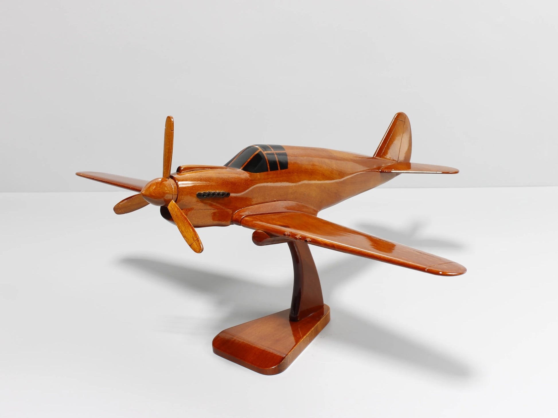 Front view of handcrafted P-40 Warhawk wood model fighter aircraft on display stand – Premiumwoodart