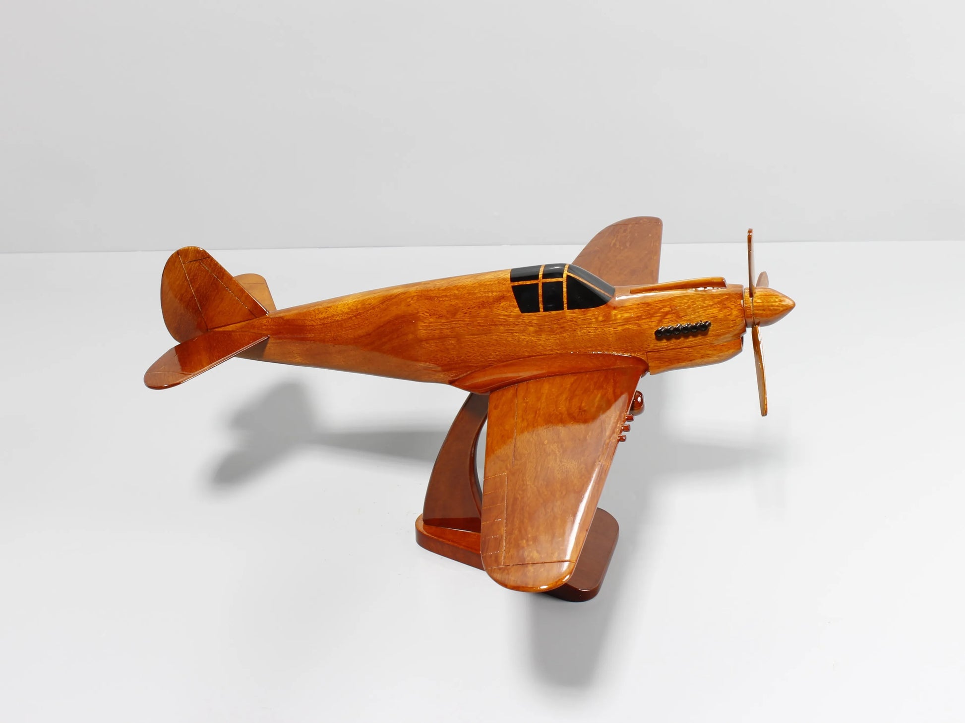 WWII-era P-40 Warhawk wood model airplane displayed on mahogany stand – Premiumwoodart