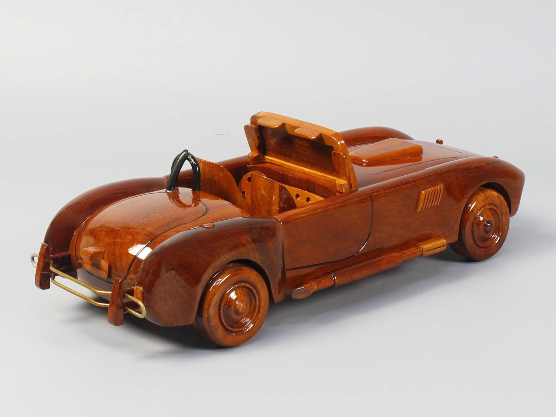 Rear-side view of Shelby Cobra wood model showing body curves