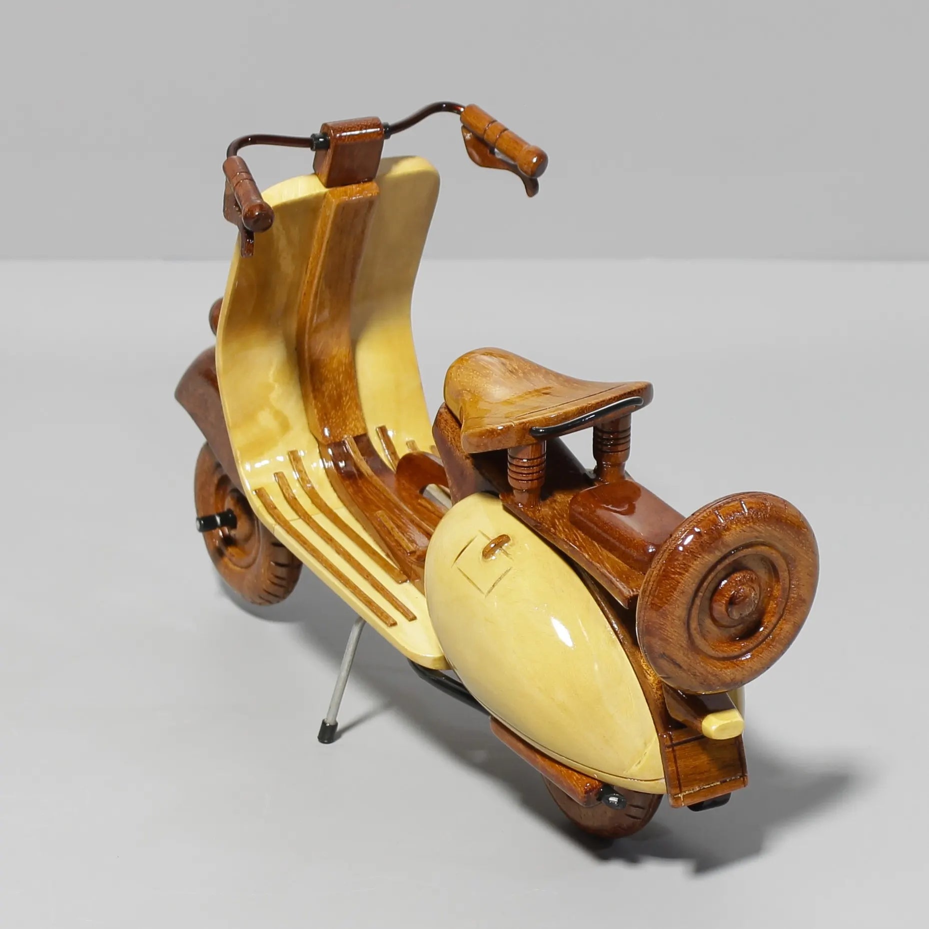Diagonal back view of handmade Vespa wood scooter model