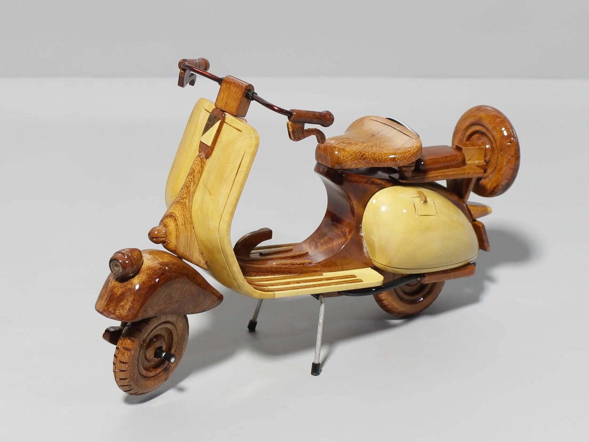 Diagonal front view of handmade Vespa wood scooter model